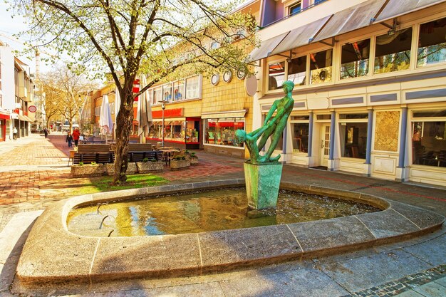 Photo fountain in the old street in hanover in germany. red thread on the pavement. hannover or hannover is a city in lower saxony of germany.