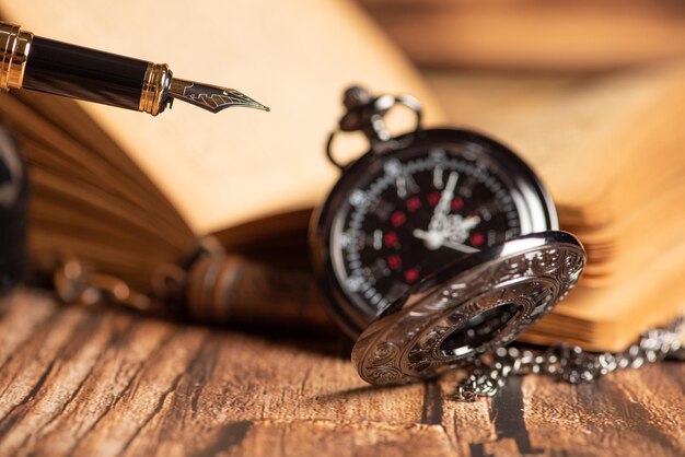 Fountain pen beautiful fountain pen in an environment with an old clock old book ink among others selective focus