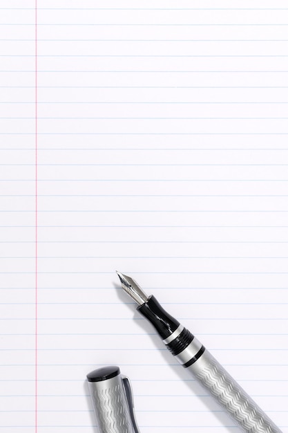 Fountain pen on blank lined paper background with Copy space