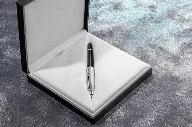 Fountain pen on a marble and gray background selective\
focus