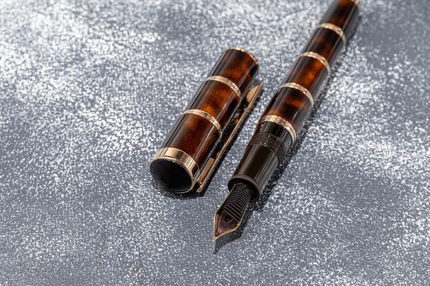Fountain pen on a marble and gray background Selective focus