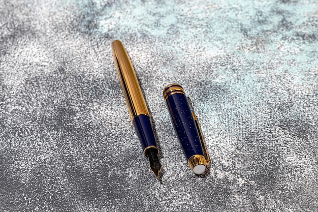 Fountain pen on a marble and gray background Selective focus