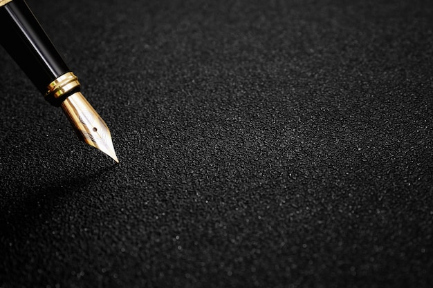 Photo fountain pen with clipping path on black textured background for signature concept