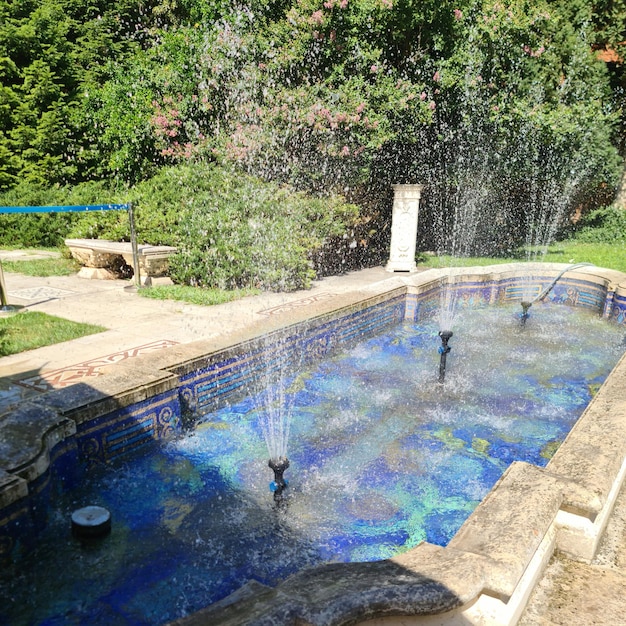 A fountain in a pool