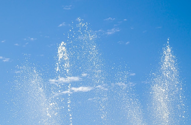 Photo fountain sprays against the sky as a background with free space for text