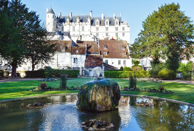 Fountain in spring public park in Loches town France and castle build in 9th century behind.