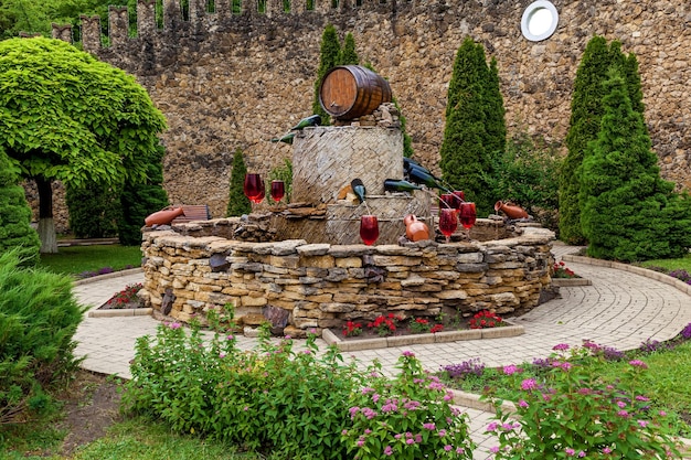 Fountain with red wine pouring from bottles