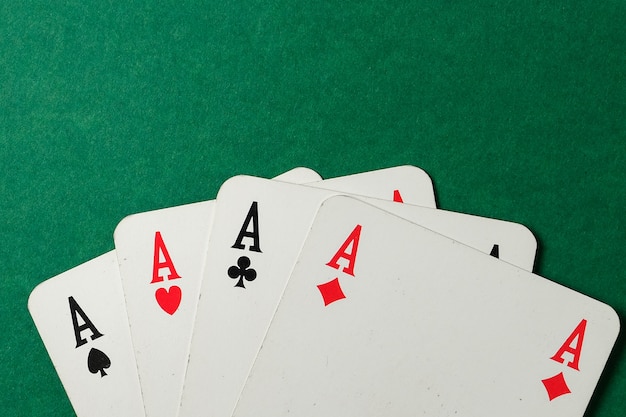 Four aces on a green background. Top view.