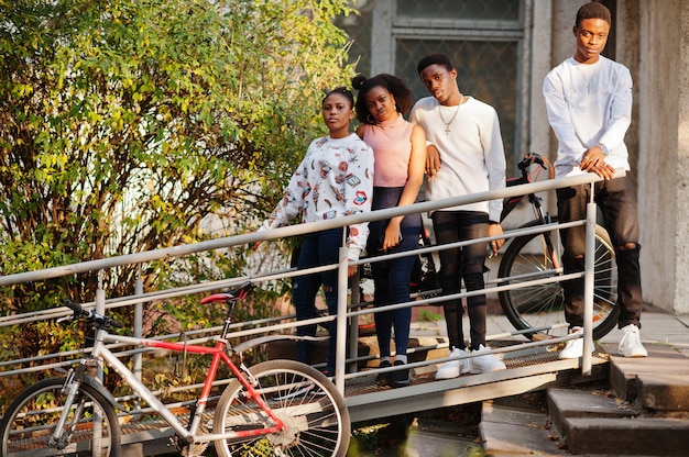 Four African friends walking together on the street