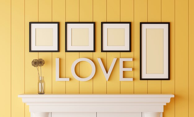 Photo four black blank picture frame on yellow wood wall with love word on the wall have flower vase placed on the fireplace.