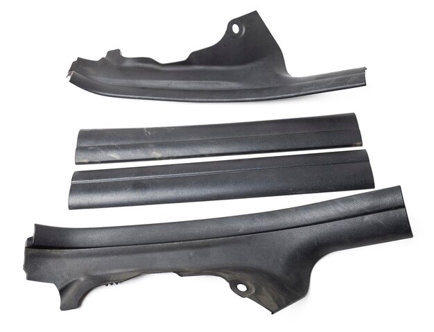 Photo a four of black plastic decorative door sills in an automobile parsing for sale or repair in a workshop on a white isolated background in a photo studio