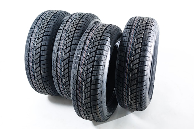 four black tires isolated on white background