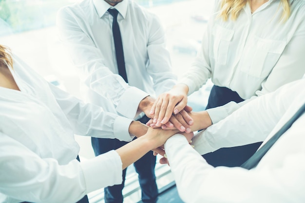 The four business people hold hands together