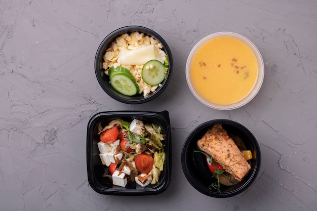 Four containers with meal, flat lay