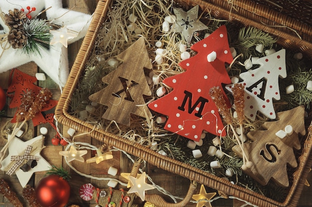 Four decorative wooden Christmas trees with carved letters xmas and christmas ornaments.