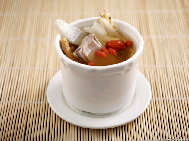 Four divinity Soup served in a pot isolated on table side view