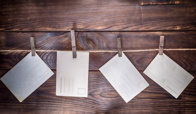 Photo four empty paper postcards hang on a rope