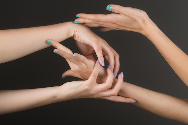 Four female hands touching