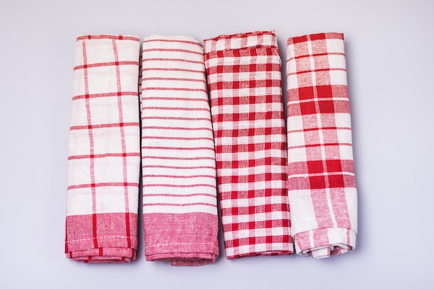 Four Folded Red White Napkin or Towels on Blue Background Top View Horizontal