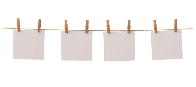 Four frames that hang on a rope with clothespins and isolated on white Blank cards on rope mockup template clipping path