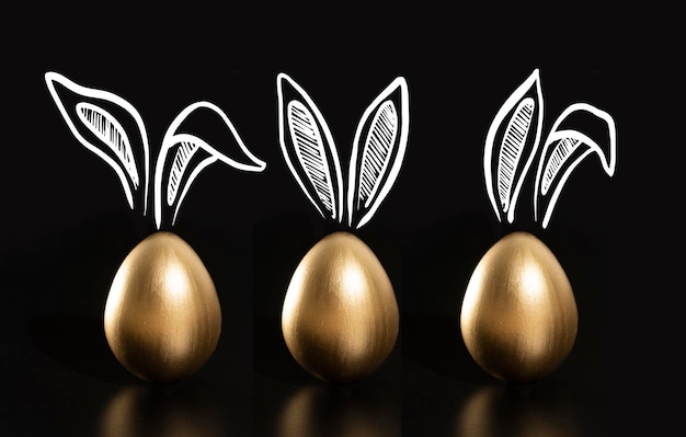 Four gold easter eggs with a bunnies on the top.