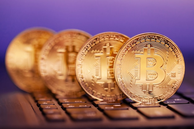 Four golden bitcoins on the keyboard