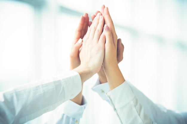 The four hands greeting with a high five