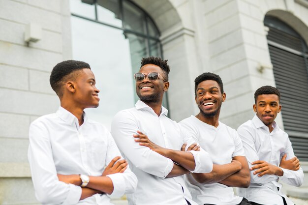 four handsome young african men in white shirts