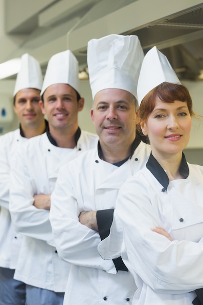 Four happy chefs smiling at the camera