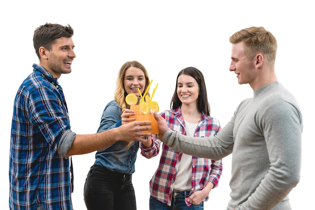 The four happy friends clink glasses on a white background