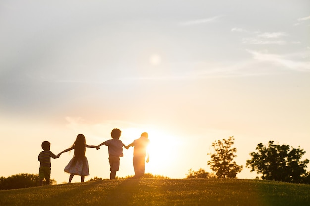 Four kids are playing on sunset.