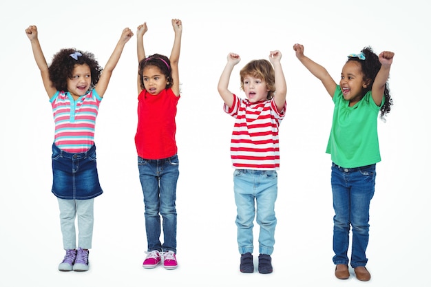 Four kids standing with arms raised in the air against a white background