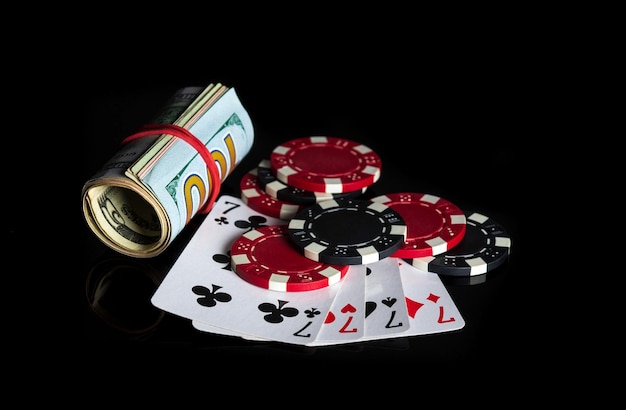 Four of a kind or quads cards combination and dollars and chips. Winning combination at a poker club or casino