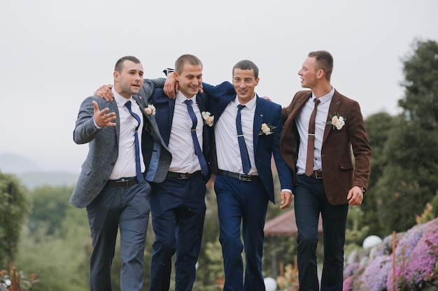 Four men in suits are walking together