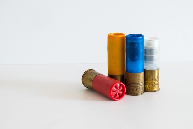 Four old 12 gauge shotgun shells used for hunting isolated on a white background