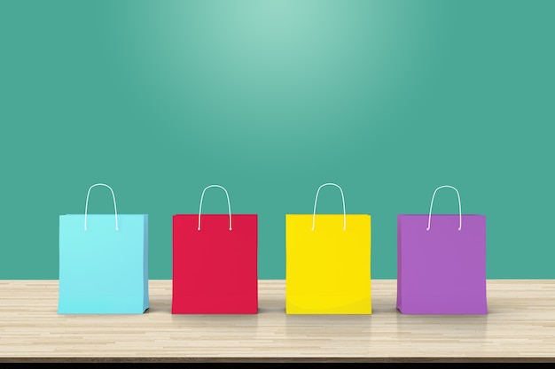 Four paper shopping bags on wood table backdrop