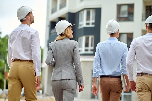 Four people carrying out a construction site inspection