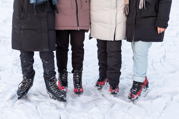 Four people on ice skates in the snow