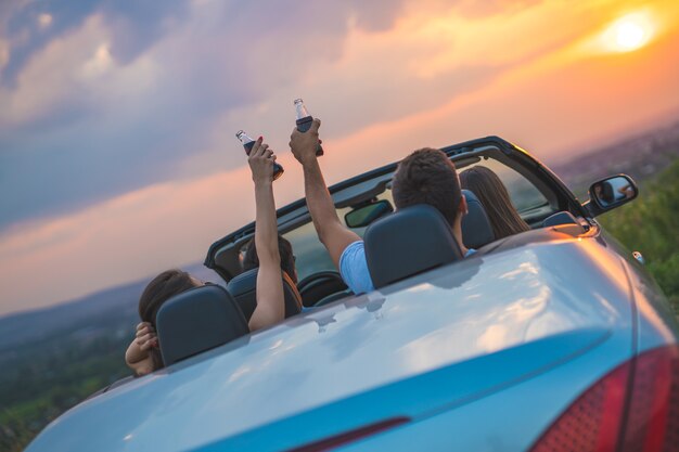 The four people sit in the cabriolet