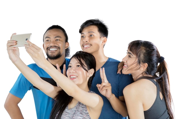 Four people taking a selfie together happily