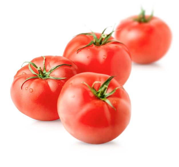 Four ripe tomatoes on a white isolated background