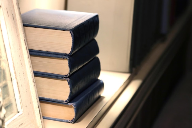 Four thick books lying on the shelf