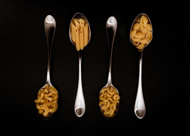 Four types of pasta in spoons