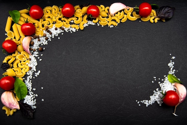 Four types of pasta with garlic pepper tomatoessalt Flatlay Top view Food Cooking Copy space