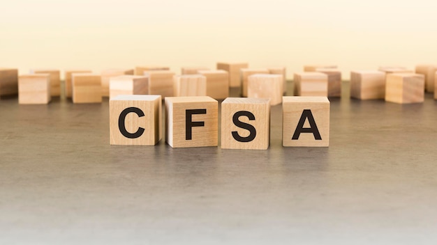 Four wooden blocks with the letters cfsa on the surface table