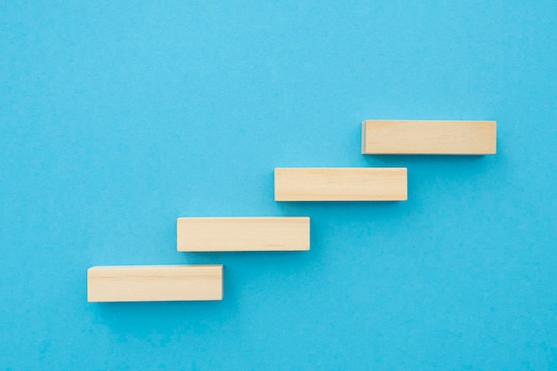 Four wooden small planks long shape with blank surface growing up on blue background