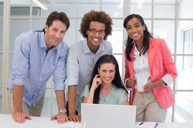 Four workers smiling to camera