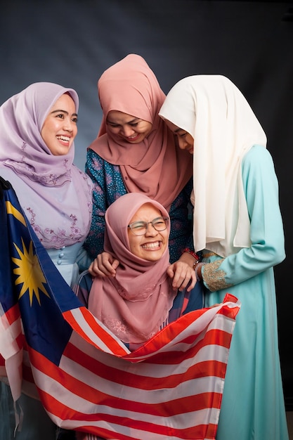 Four young beautiful Asian Muslim fashion models have fun and laughing in traditional dress