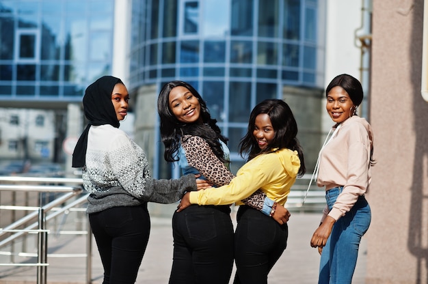 Four young college african american woman friends spend time together.