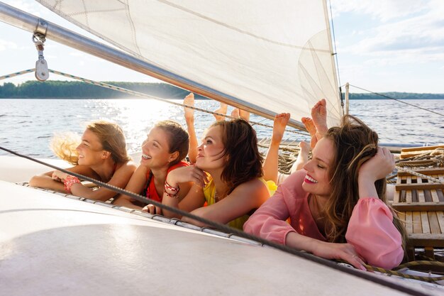 Four young women relaxing on a sailing yacht